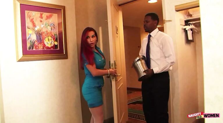The redheaded Helena Hughes seduces the black room service guy with her curvy milf body